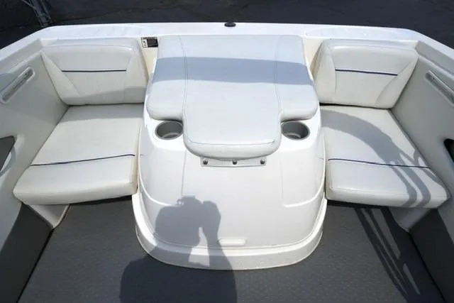 Slide: The Image of 2006 Bayliner 195 Classic boat interior with white seating and cup holders. - 14