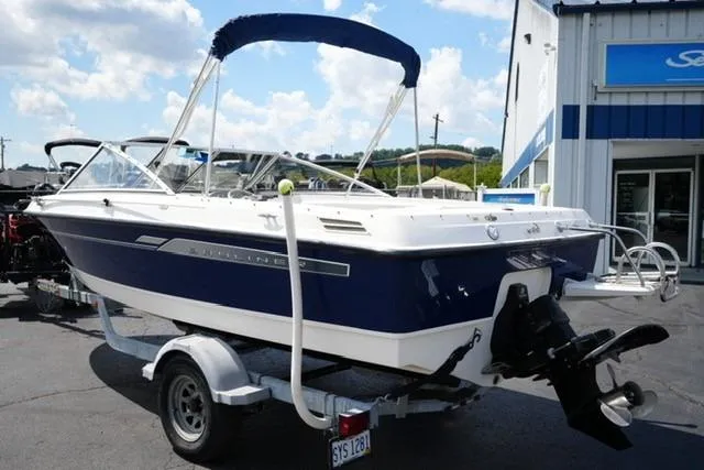Slide: The Image of 2006 Bayliner 195 Classic boat on trailer, parked outside dealership. - 5