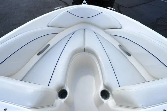 Slide: The Image of 2006 Bayliner 195 Classic boat interior with white cushioned seating. - 6