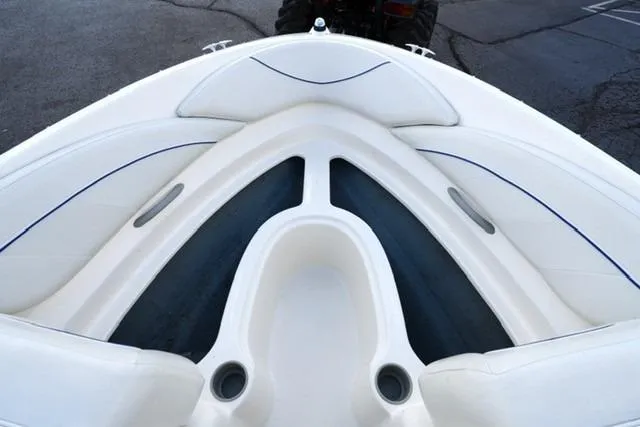 Slide: The Image of 2006 Bayliner 195 Classic boat interior with white seating and blue accents. - 7