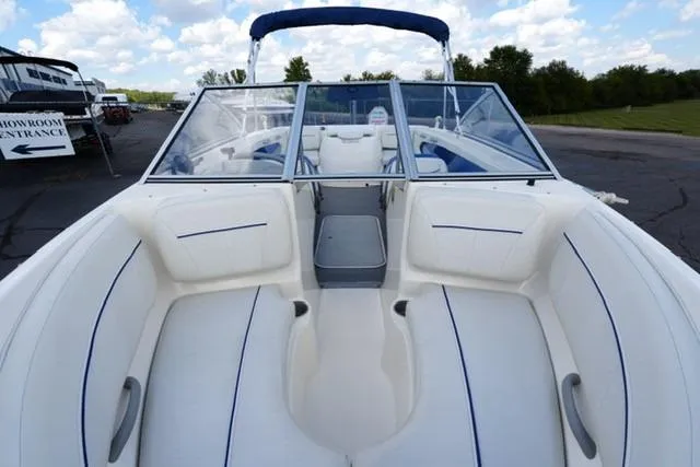Slide: The Image of 2006 Bayliner 195 Classic boat interior with white seating and blue accents. - 8