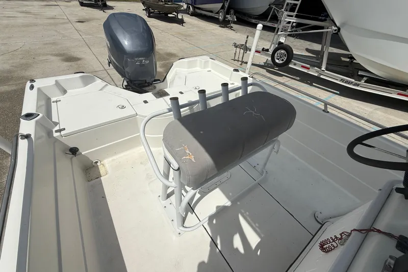 Slide: The Image of 2003 Skeeter ZX2400 boat deck with Yamaha outboard motor, featuring storage compartments. - 11
