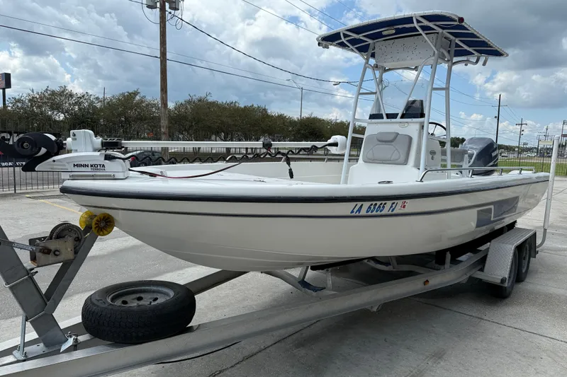 Slide: The Image of 2003 Skeeter ZX2400 boat with Yamaha outboard motor on a trailer, parked outdoors. - 4