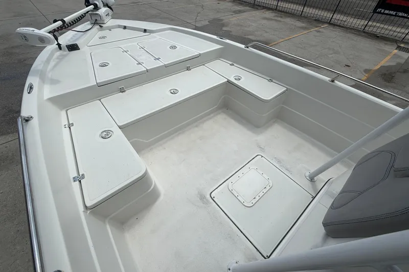 Slide: The Image of 2003 Skeeter ZX2400 boat with spacious deck and storage compartments, docked outdoors. - 9