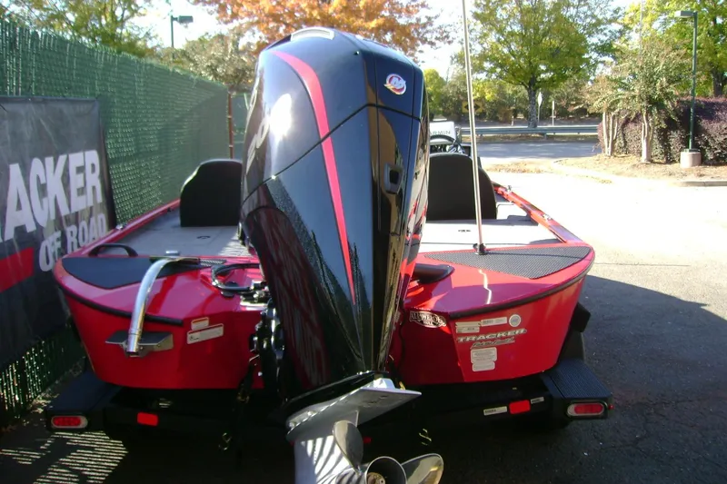 Slide: The Image of 2026 Tracker Savage 215 boat with powerful outboard motor, parked outdoors. - 66