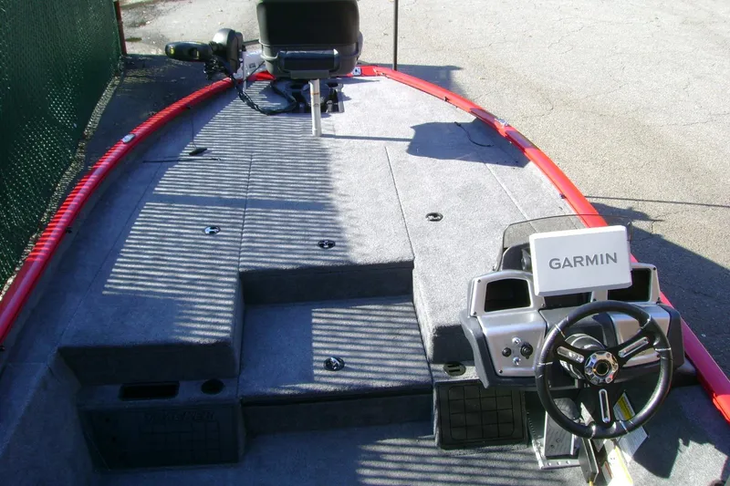 Slide: The Image of 2026 Tracker Savage 215 boat interior with Garmin navigation system and steering wheel. - 68