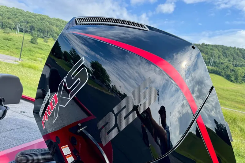 Slide: The Image of 2026 Tracker Savage 215 boat engine with Mercury Pro XS branding, outdoors. - 4