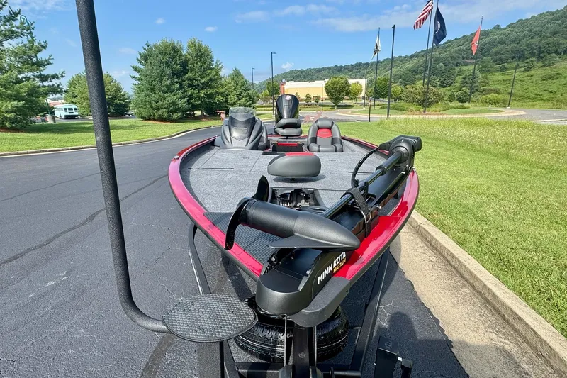 Slide: The Image of 2026 Tracker Savage 215 boat with Minn Kota motor on a sunny day. - 9