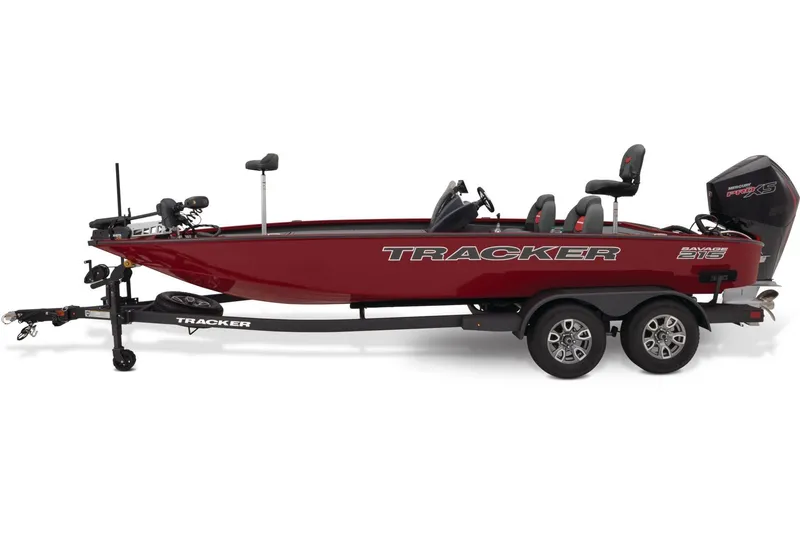 Slide: The Image of 2026 Tracker Savage 215 boat on trailer, displayed outdoors near service area. - 2
