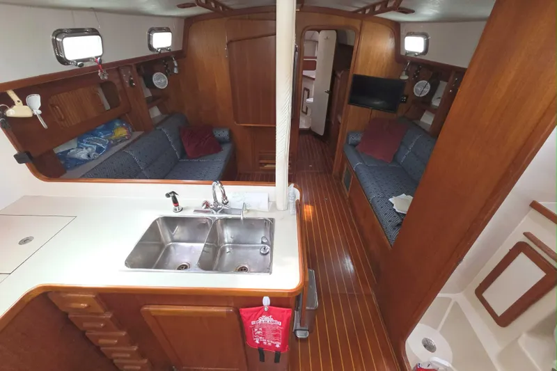 Slide: The Image of Interior of 2001 Caliber 40LRC yacht with wooden finish and cozy seating area. - 11