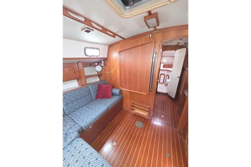 Slide: The Image of Interior of 2001 Caliber 40LRC sailboat with wooden finish and cozy seating area. - 13