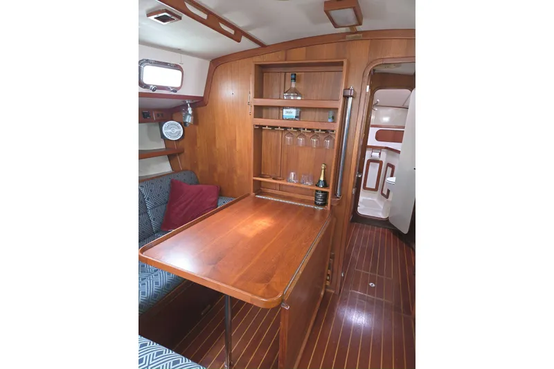 Slide: The Image of Cozy 2001 Caliber 40LRC yacht interior with wooden dining area and built-in bar. - 14