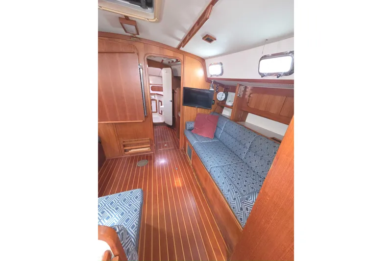 Slide: The Image of Interior of 2001 Caliber 40LRC sailboat with wooden finish and patterned seating. - 16