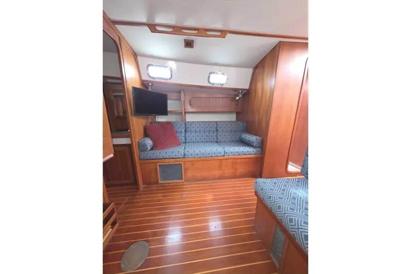 Slide: The Image of Interior of 2001 Caliber 40LRC sailboat with wooden flooring and cushioned seating. - 18