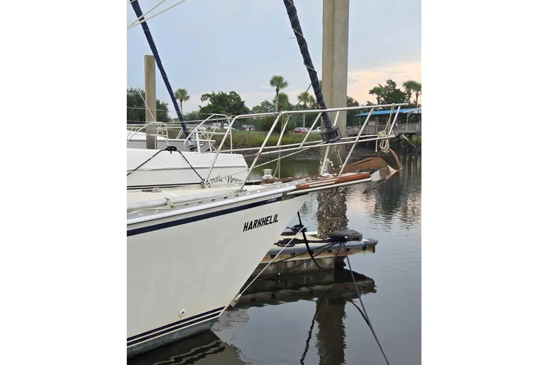 Slide: The Image of Sailboat docked in marina, Caliber 40LRC 2001 model, calm water reflection. - 2