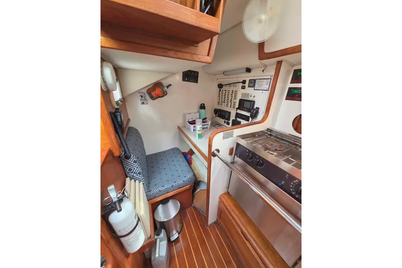 Slide: The Image of 2001 Caliber 40LRC yacht interior with navigation station and galley area. - 20