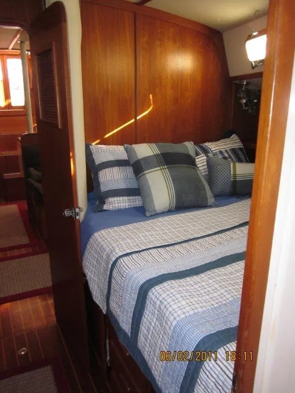 Slide: The Image of Cozy cabin interior of 2001 Caliber 40LRC sailboat with plaid bedding. - 25