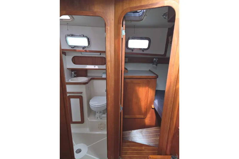 Slide: The Image of Interior of 2001 Caliber 40LRC yacht showing bathroom and cabin with wooden finish. - 31