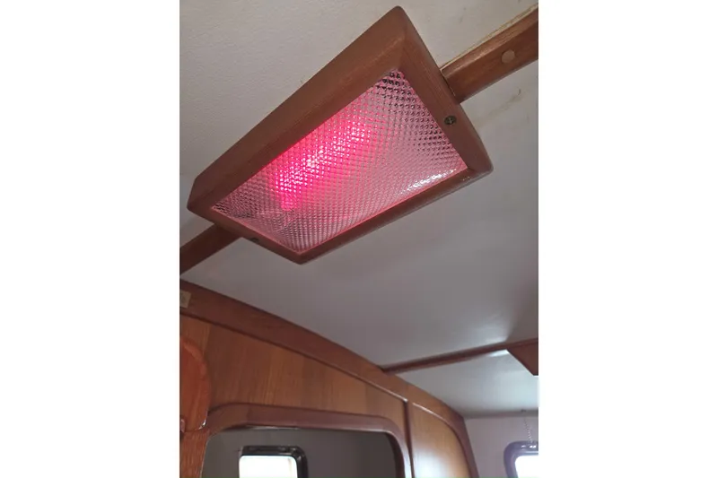 Slide: The Image of Red ceiling light inside 2001 Caliber 40LRC boat cabin with wooden trim. - 33