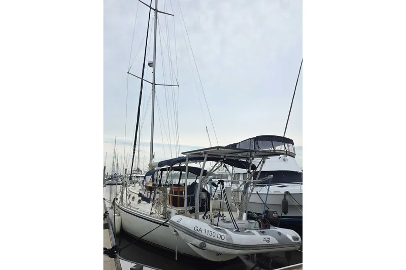 Slide: The Image of 2001 Caliber 40LRC sailboat docked at marina, overcast sky background. - 4
