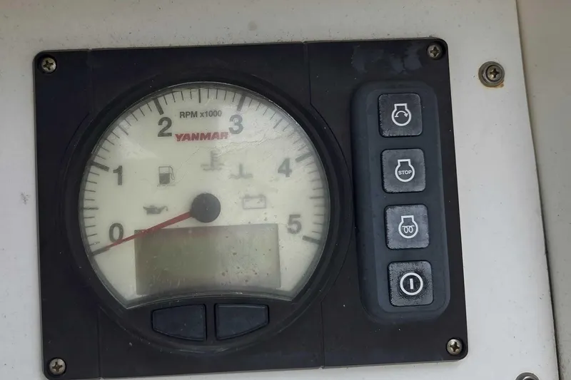 Slide: The Image of Yanmar RPM gauge and control panel on a 2001 Caliber 40LRC boat. - 9