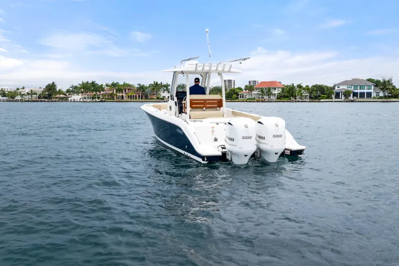 Slide: The Image of 2019 Pursuit S 288 Sport boat bow with tan seating on calm water. - 16