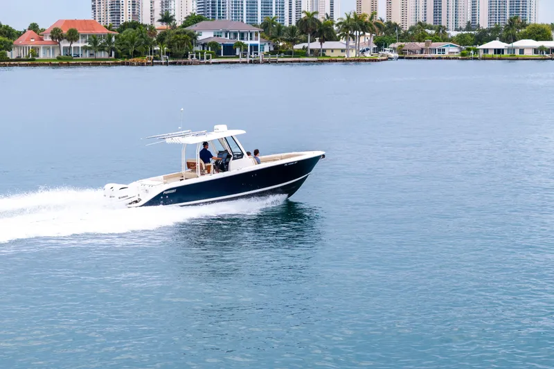 Slide: The Image of 2019 Pursuit S 288 Sport boat on water, featuring dual Yamaha engines. - 2