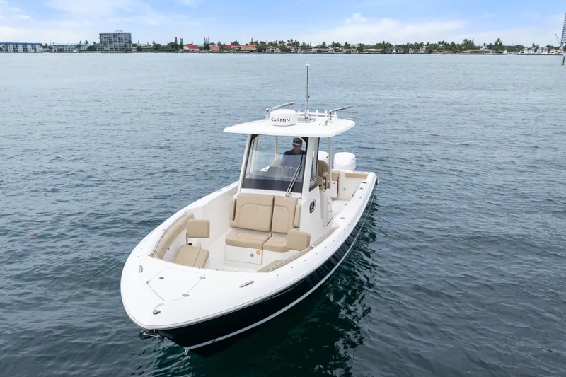 Slide: The Image of 2019 Pursuit S 288 Sport boat interior with helm, seating, and ocean view. - 24