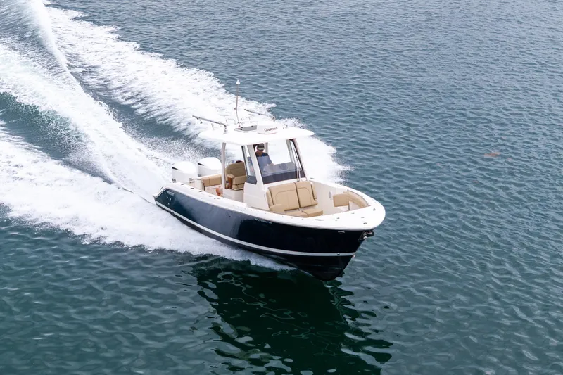 Slide: The Image of 2019 Pursuit S 288 Sport boat on calm blue water, featuring sleek design and comfortable seating. - 4