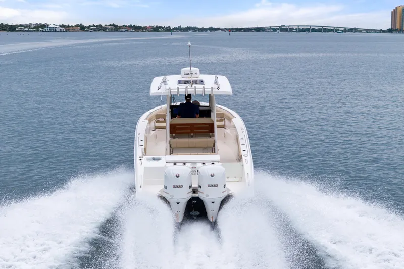 Slide: The Image of 2019 Pursuit S 288 Sport boat with dual Yamaha engines on open water. - 5