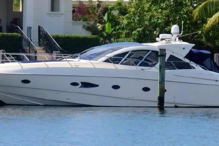 Slide: The Image of 2010 Azimut Atlantis 54 yacht docked by waterfront home. - 2