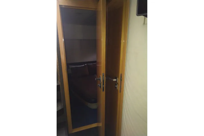 Slide: The Image of Interior view of 2010 Azimut Atlantis 54 yacht cabin through wooden door. - 21