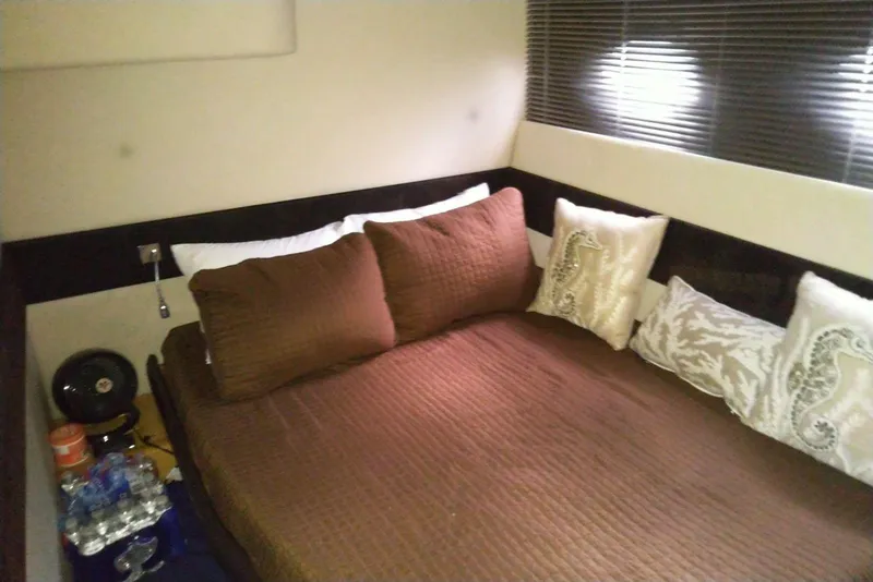 Slide: The Image of Cozy bedroom interior of 2010 Azimut Atlantis 54 yacht with brown bedding and decorative pillows. - 22