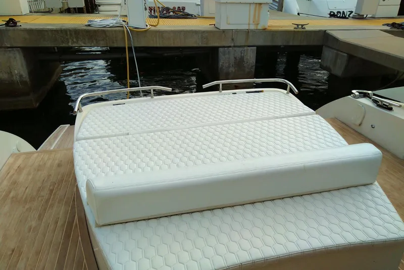 Slide: The Image of 2010 Azimut Atlantis 54 yacht with white cushioned seating at the dock. - 6