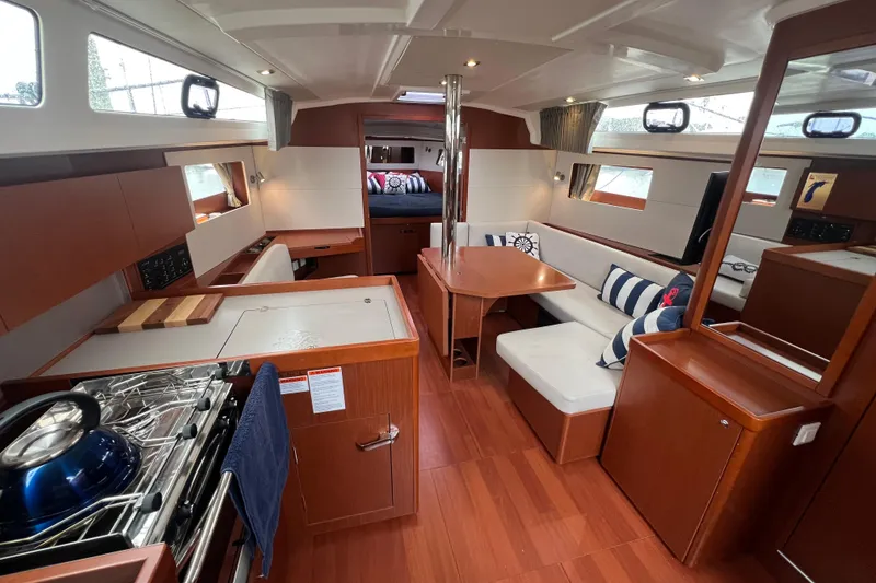 The Image of Interior of 2020 Beneteau Oceanis 41.1 yacht with modern kitchen and cozy seating area. - 0