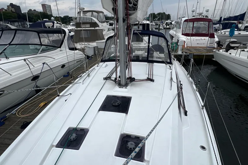 Slide: The Image of 2020 Beneteau Oceanis 41.1 sailboat docked in a marina, surrounded by other boats. - 11