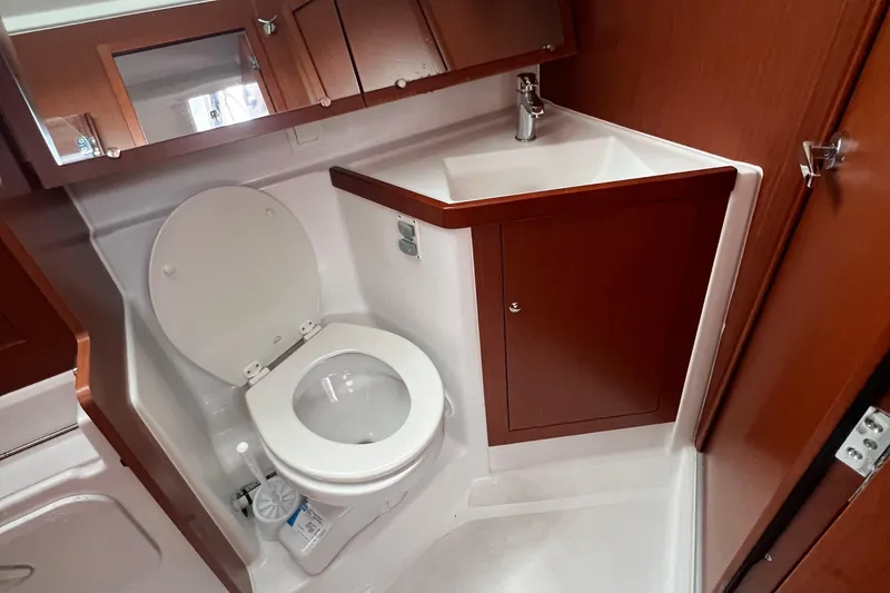 Slide: The Image of Beneteau Oceanis 41.1 2020 yacht bathroom with toilet and sink, wooden cabinetry. - 4