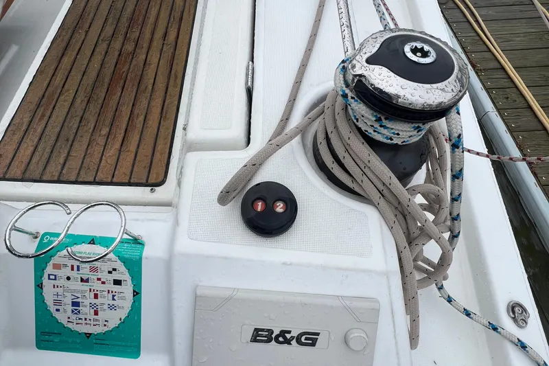 Slide: The Image of Deck of 2020 Beneteau Oceanis 41.1 with winch, ropes, and nautical chart. - 8