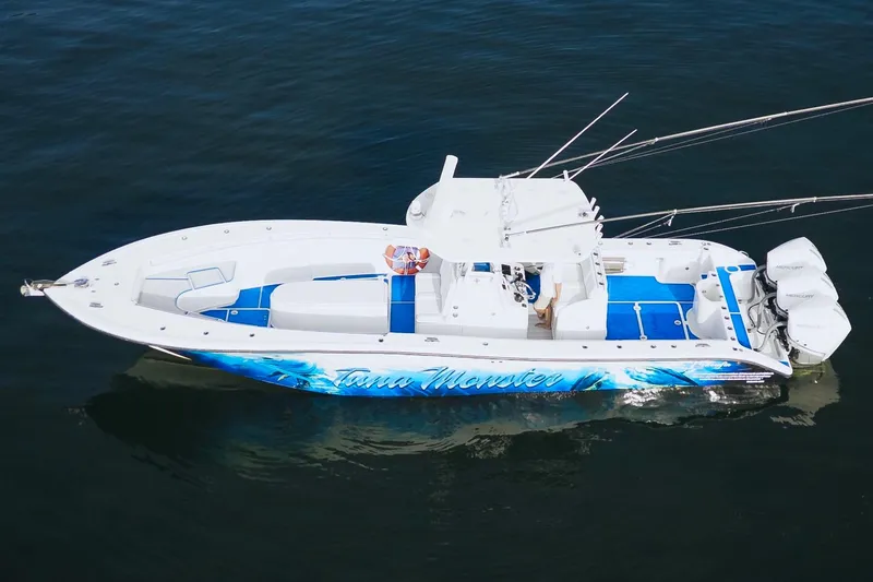 Slide: The Image of 2007 Yellowfin 36 Offshore boat with vibrant blue accents on calm water. - 10