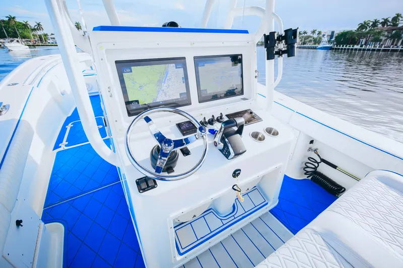 Slide: The Image of 2007 Yellowfin 36 Offshore boat cockpit with dual navigation screens and blue accents. - 13