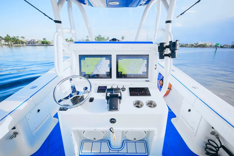 Slide: The Image of 2007 Yellowfin 36 Offshore boat cockpit with dual navigation screens and steering wheel. - 14