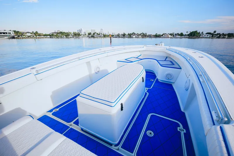 Slide: The Image of 2007 Yellowfin 36 Offshore boat with blue deck, spacious seating, and scenic waterfront view. - 15
