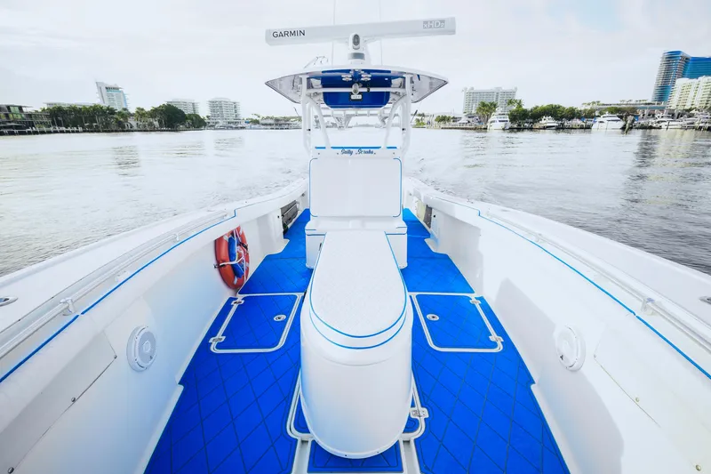 Slide: The Image of 2007 Yellowfin 36 Offshore boat with blue deck, docked in a marina. - 16