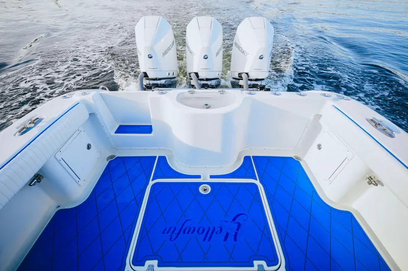 Slide: The Image of 2007 Yellowfin 36 Offshore boat with triple Mercury engines and blue deck flooring. - 18
