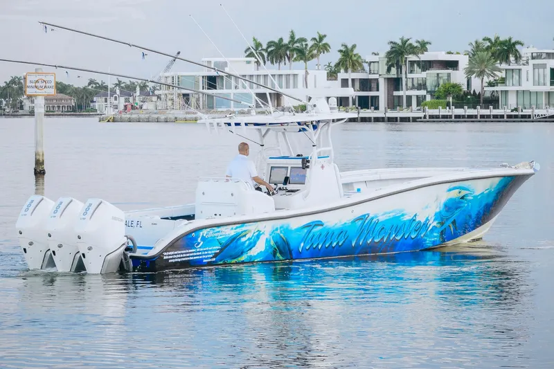 Slide: The Image of 2007 Yellowfin 36 Offshore boat with vibrant ocean-themed graphics on calm water. - 5