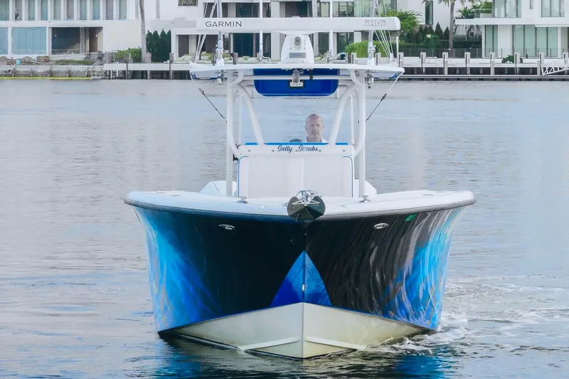 Slide: The Image of 2007 Yellowfin 36 Offshore boat on water, featuring a striking blue hull design. - 6