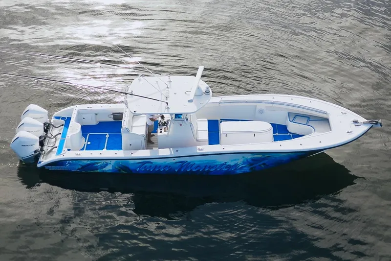 Slide: The Image of 2007 Yellowfin 36 Offshore boat with triple Mercury engines on calm water. - 9
