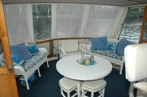 Slide: The Image of 1969 Chris-Craft 47 Commander interior with cozy seating and round table. - 10