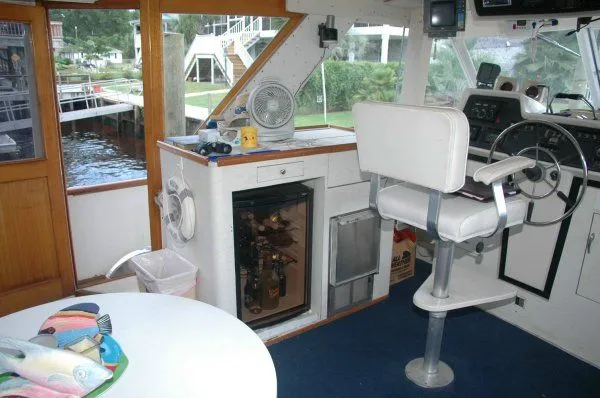 Slide: The Image of Interior of 1969 Chris-Craft 47 Commander yacht with helm, seating, and mini fridge. - 11