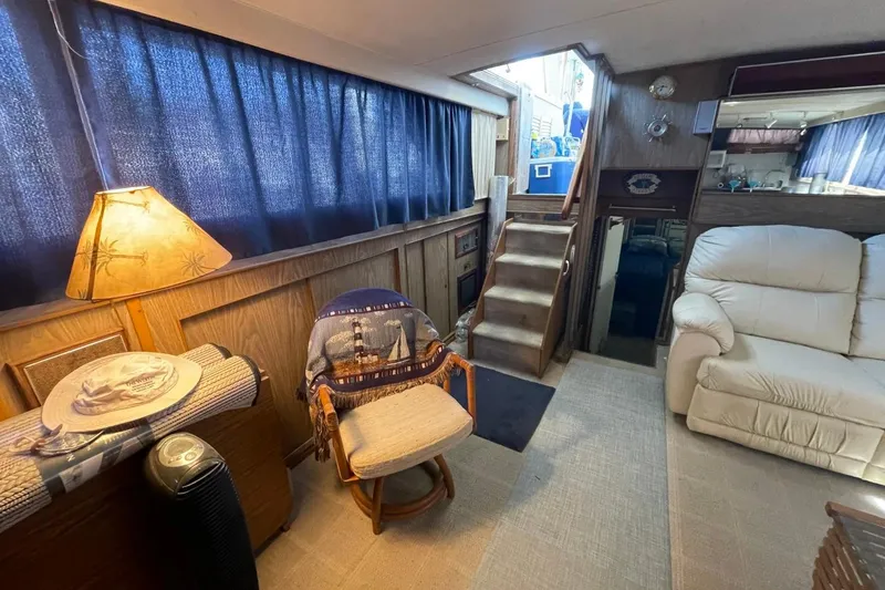 Slide: The Image of Interior of a 1969 Chris-Craft 47 Commander yacht with cozy seating and nautical decor. - 17